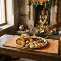 AI illustration of prasad offering: sweets, flowers and a lit diya on a brass plate before a temple altar.